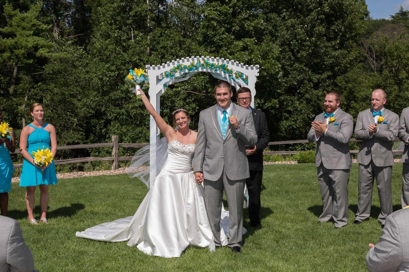A newly married couple celebrating with their wedding party after the ceremony