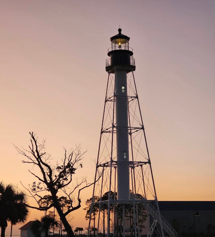 Cape San Blas Lighthouse lit at sunset in George Core Park, Port St. Joe